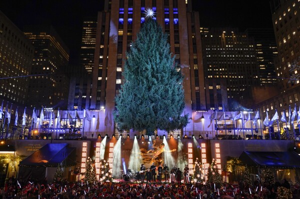 Iconic Christmas tree at Rockefeller Center illuminated AP News